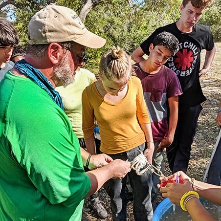 A group of students looking at crab in Texas.