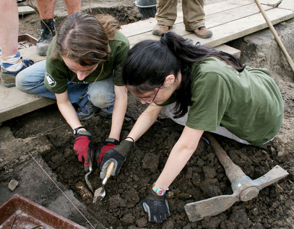Two teen Earthwatch volunteers doing archaeology fieldwork.
