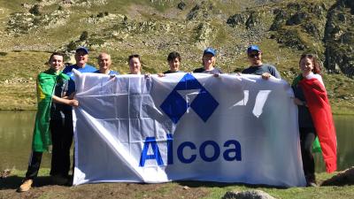 Alcoa employees holding an Alcoa flag