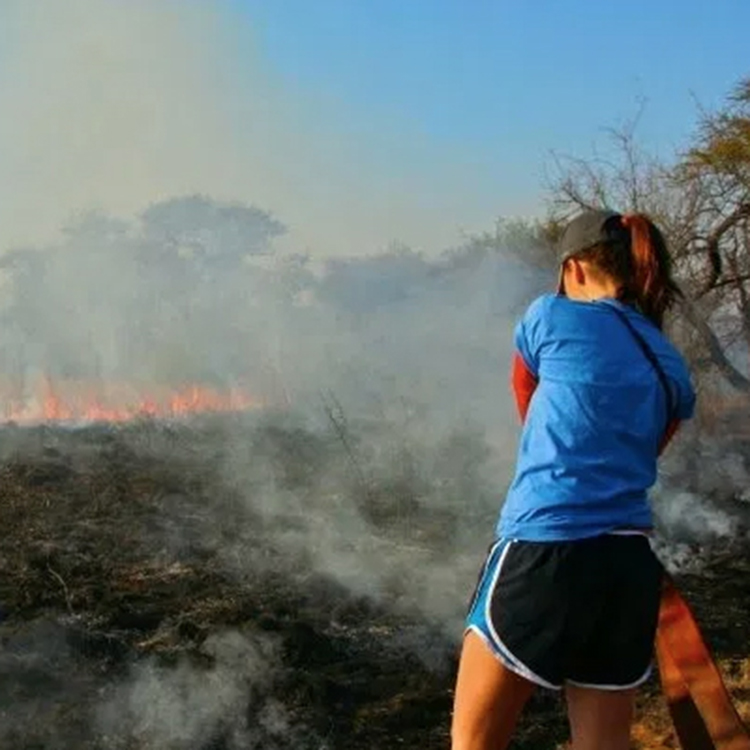 Taylor monitoring the edges of the controlled burn site.