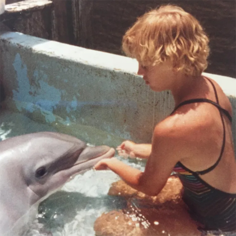 Chip’s mother, Julie, working with a dolphin during an Earthwatch expedition in Hawaii