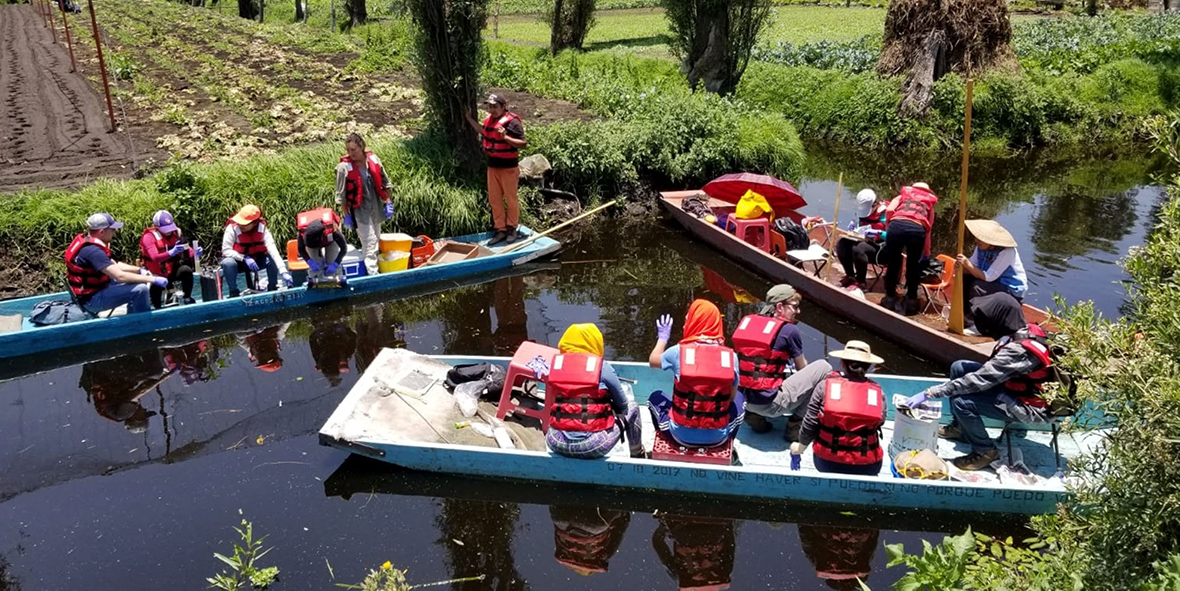 EY volunteers floating in a waterway