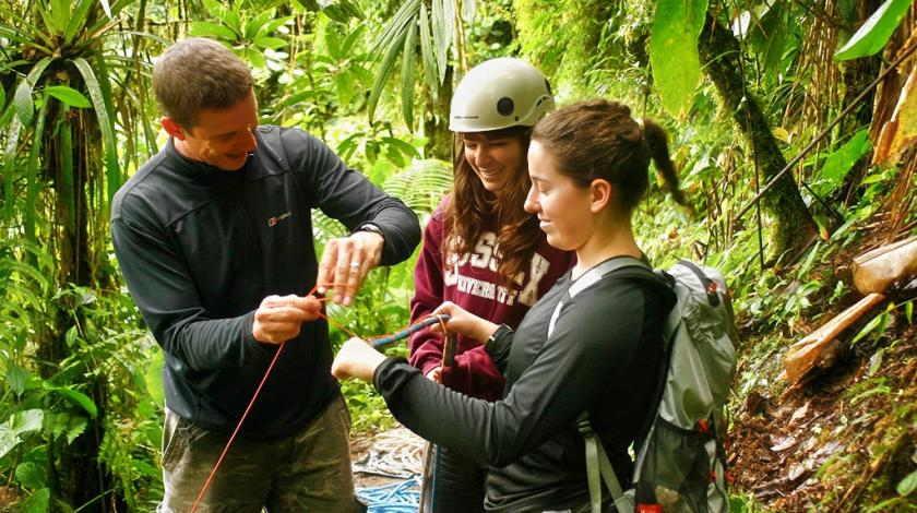 Volunteers stop to look at discoveries in the jungle