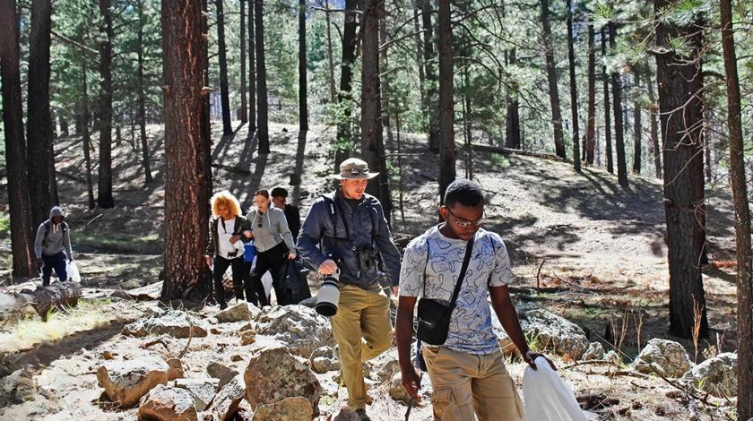 A group of students walking to the field site in Arizona with their teacher.