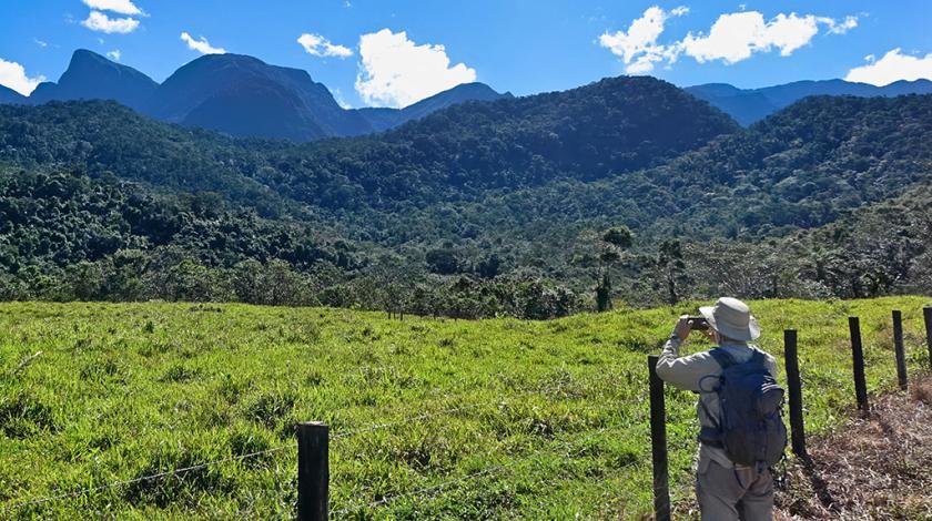 A participant stops to take a photo of one of the Atlantic Forest's many scenic views (C) Ashley Junger