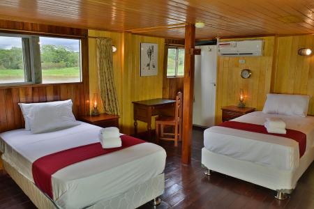 All cabins have single beds (no bunk or double beds), air-conditioning (runs only while generator is on), a desk, and a wardrobe. 