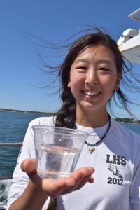 Eugena holding water that is being tested for salinity.