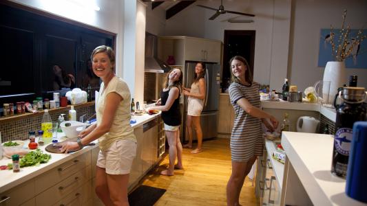 Earthwatch volunteers cooking in shared kitchen