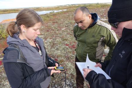 Three Earthwatch volunteers recording environmental data