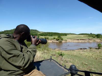 An Earthwatch research team photographs wildlife at a watering hole (C) Mary Rowe