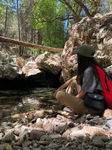 An Earthwatch volunteer rests by a stream in Arizona (C) David Recendiz