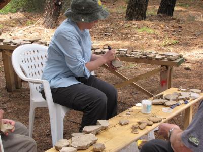 An Earthwatch volunteer helps clean and catalog artifacts