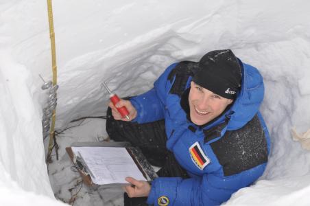 A volunteer records the temperature of the snow at various depths.© Jo Anne Croft, Earthwatch