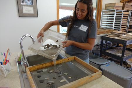 earthwatch volunteer processes artifacts in the lab