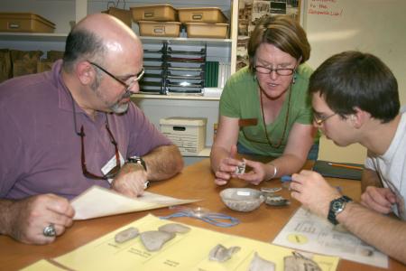 earthwatch volunteers examine artifacts