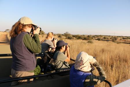 Earthwatch volunteers observing rhinos in the field