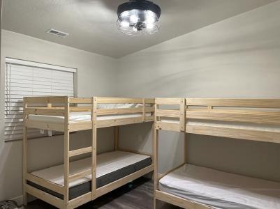 The home has four bedrooms—2 with 4 bunk beds. If the team is full, at least four people will need to use the top bunk of a bunk bed. Photo credit: https://www.airbnb.com/rooms/46283136  